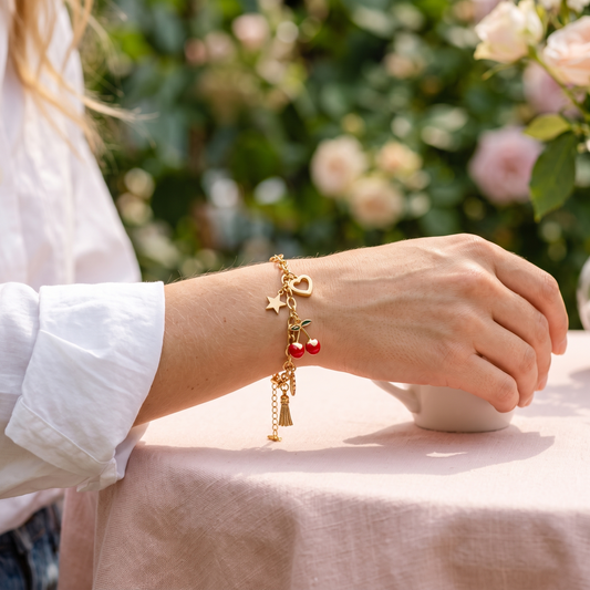 Star heart cherry tassel bracelet worn, front view