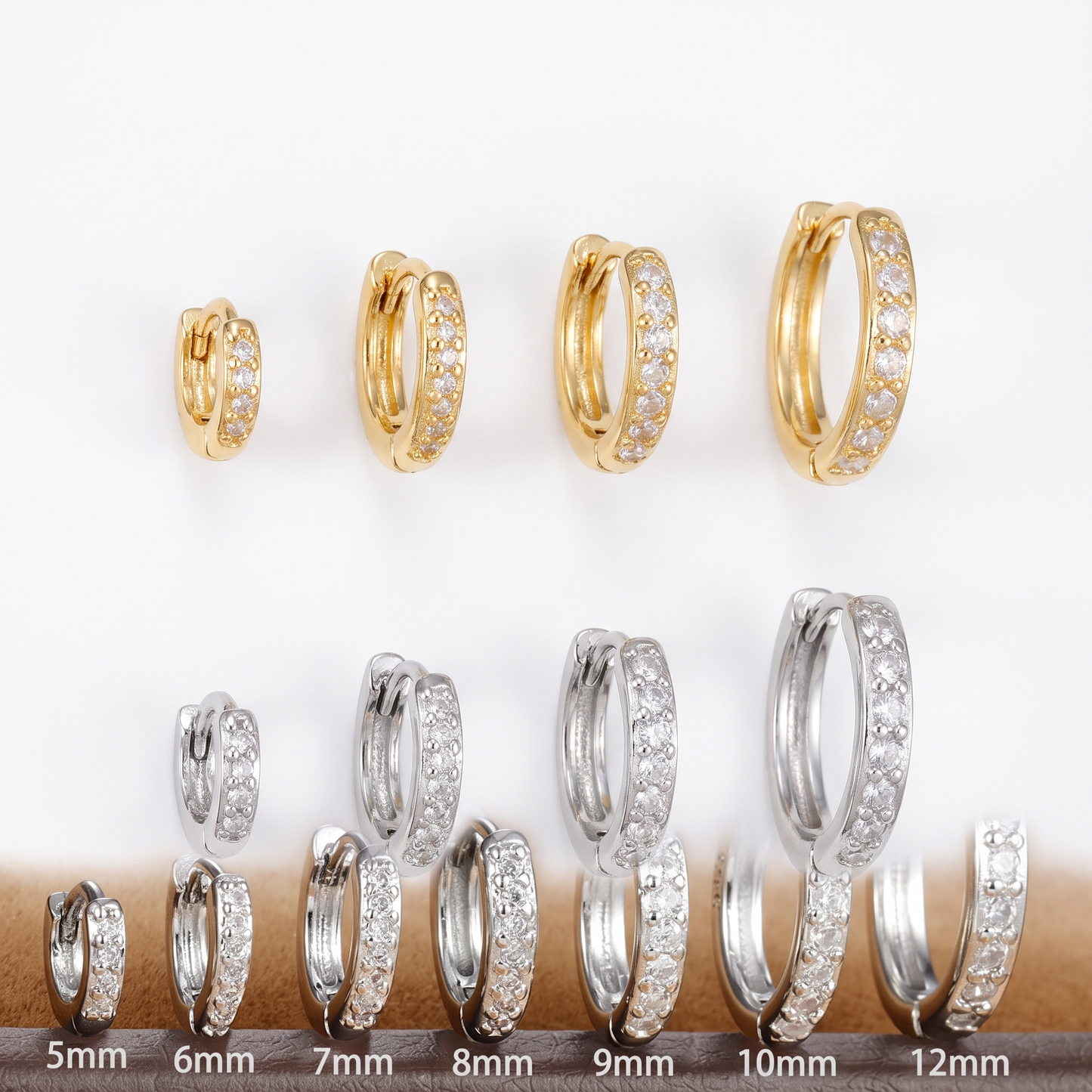 CZ huggie hoop shown in four sizes, gold and silver