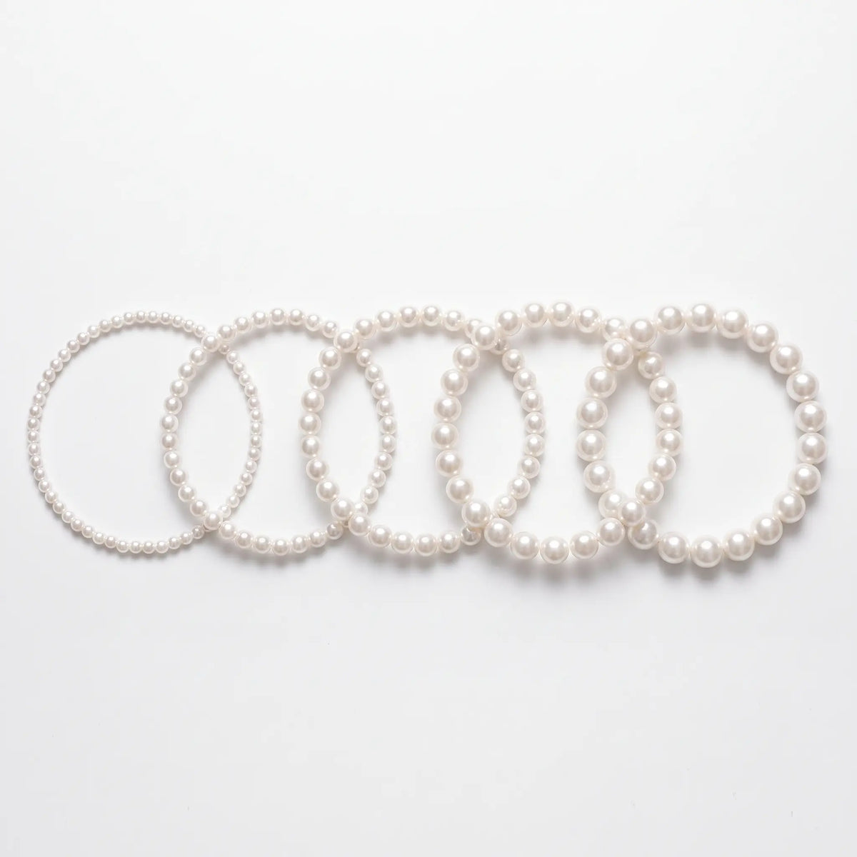 Pearl chokers shown in five bead sizes