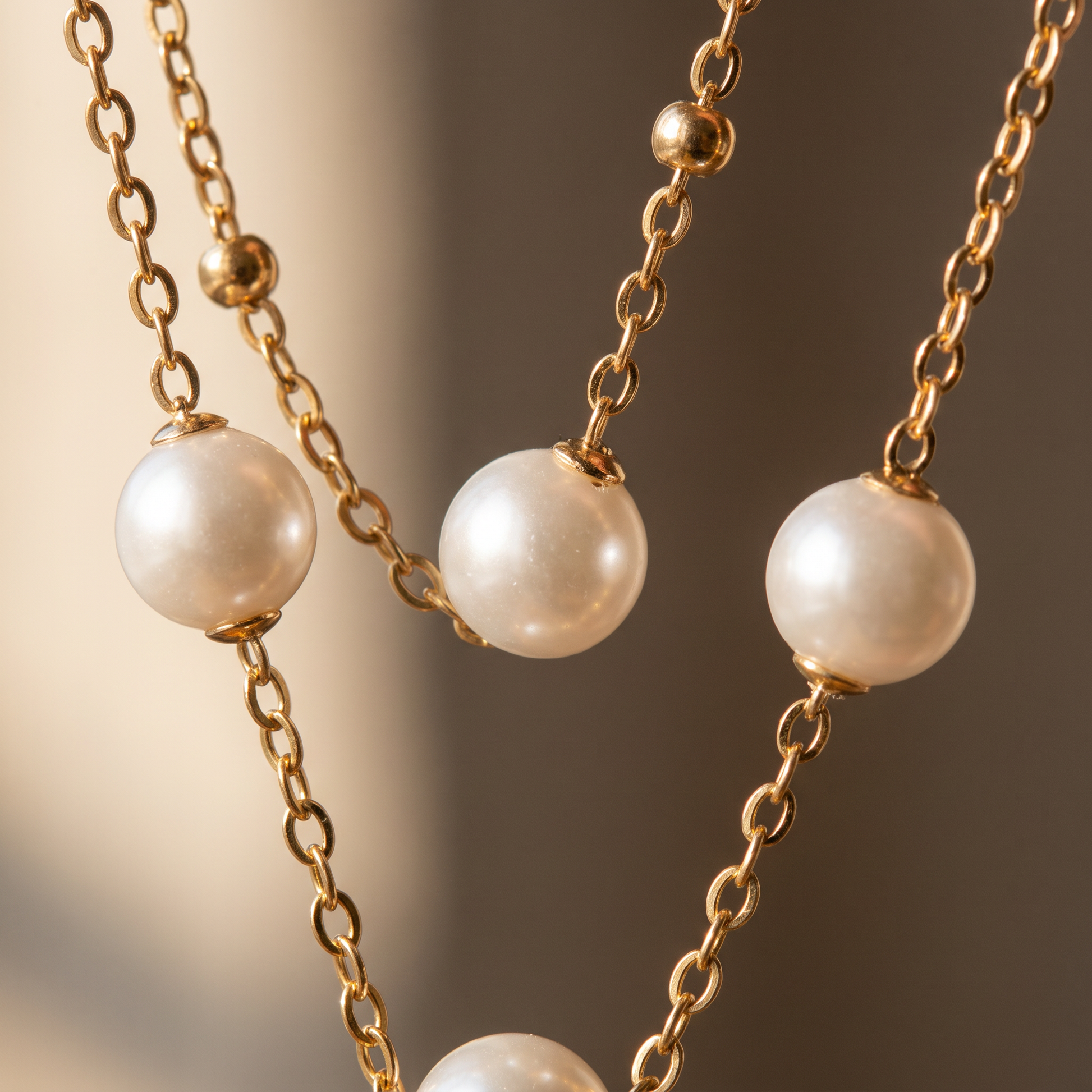 Close-up detail of the pearl beads and fine gold chain
