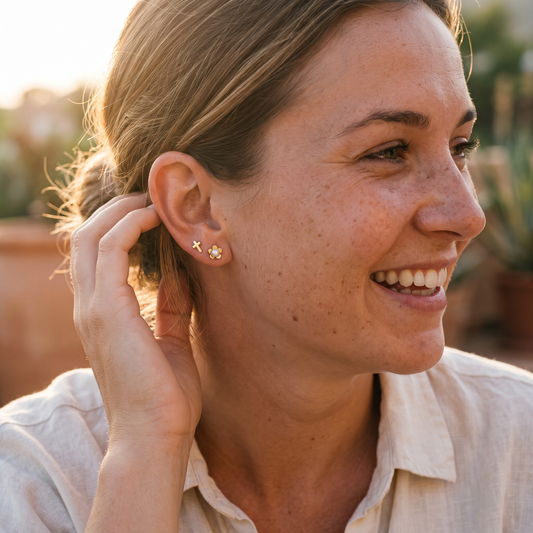 Flower and cross pearl studs worn, second angle