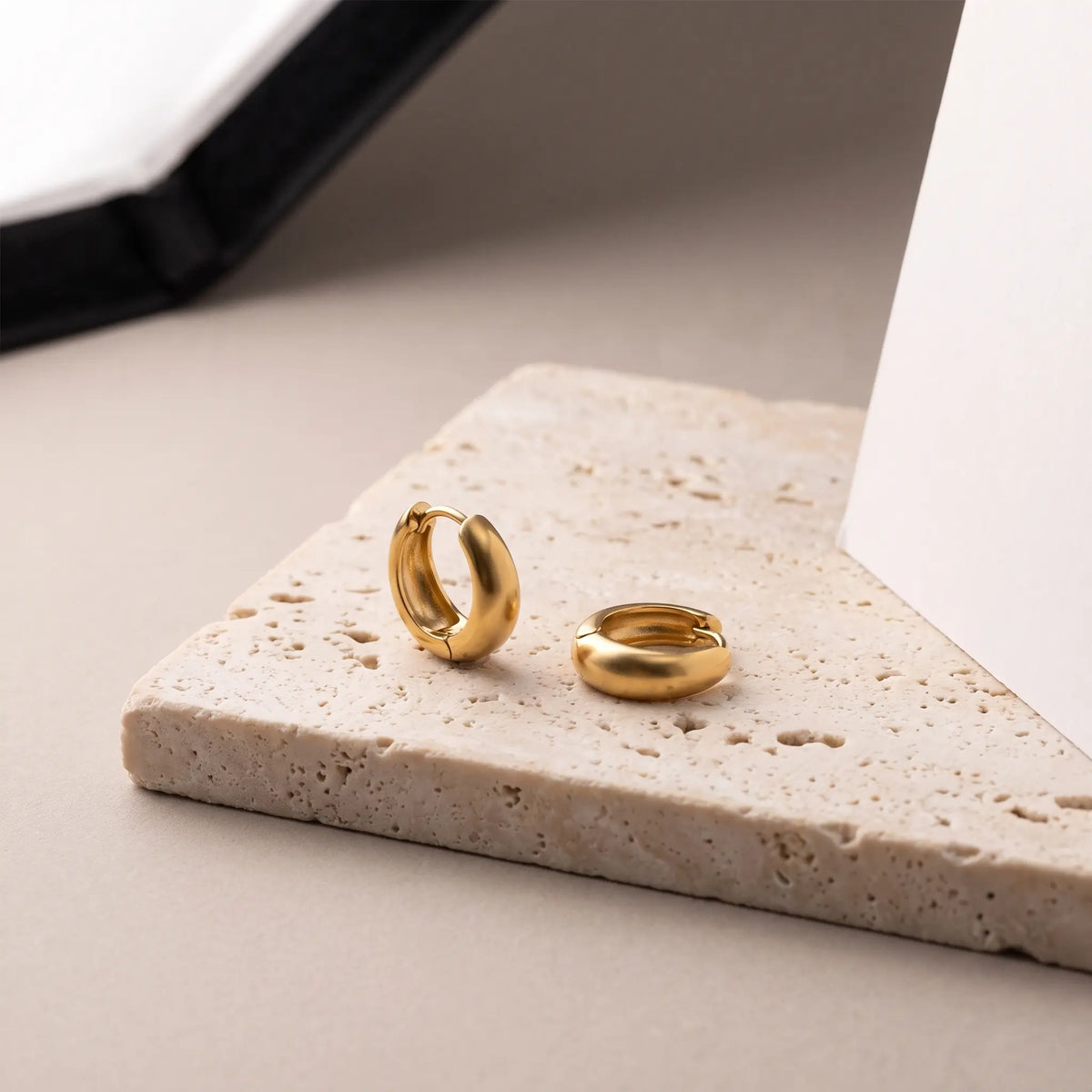 Minimalist huggie hoops product shot