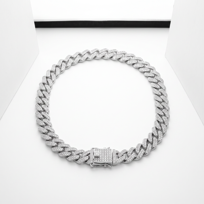 Iced Out 14MM Prong Cuban Link Chain in silver, laid on a white studio background