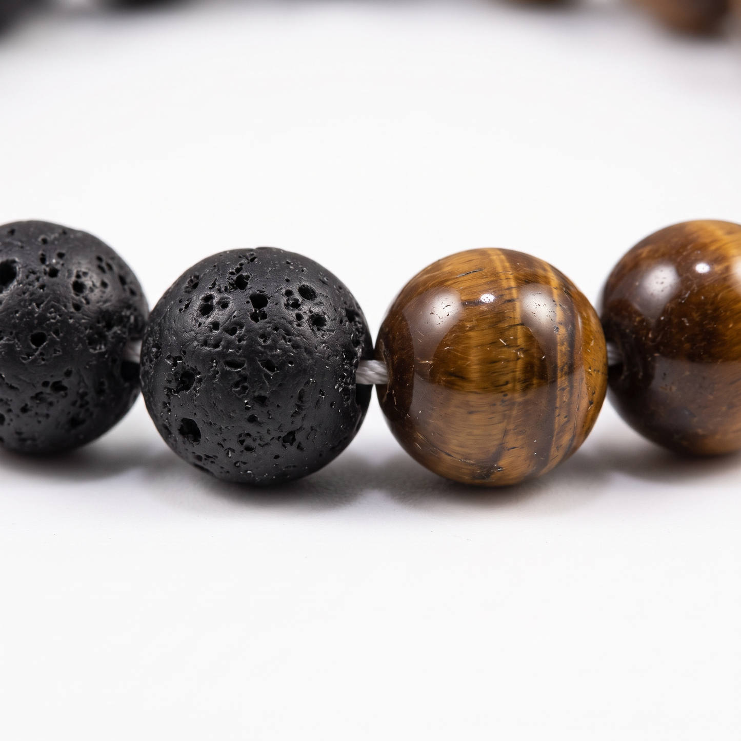 Close-up of lava stone and tiger's eye beads