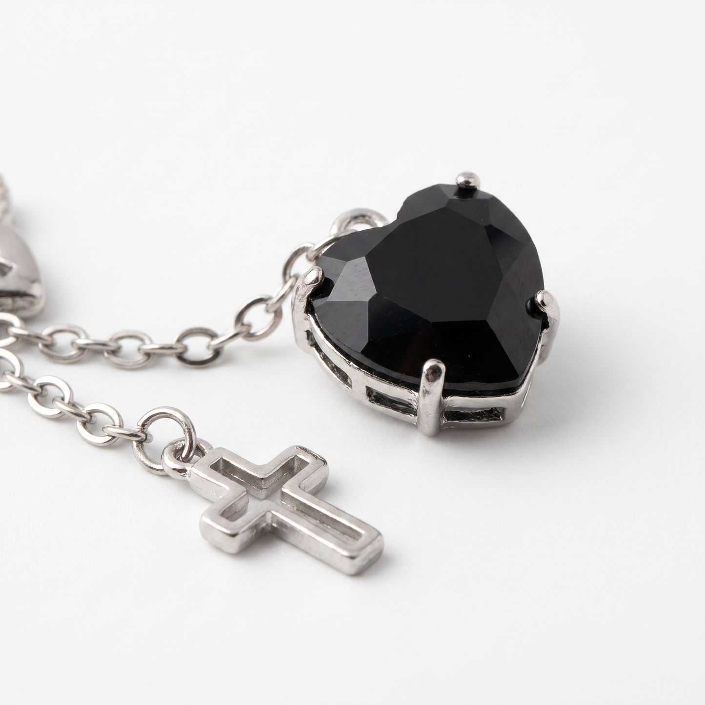 Close-up of heart and cross charms