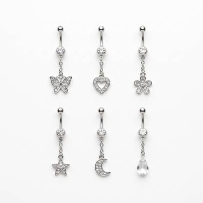 Six dangle belly ring styles laid out