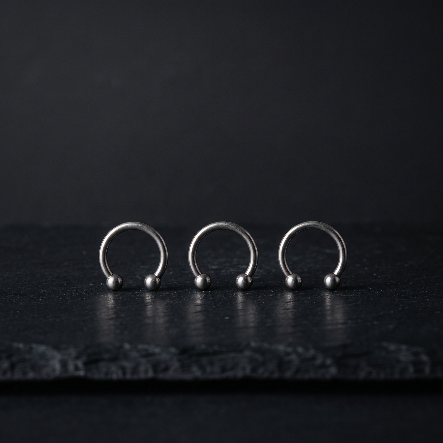 Three faux horseshoe septum rings product shot