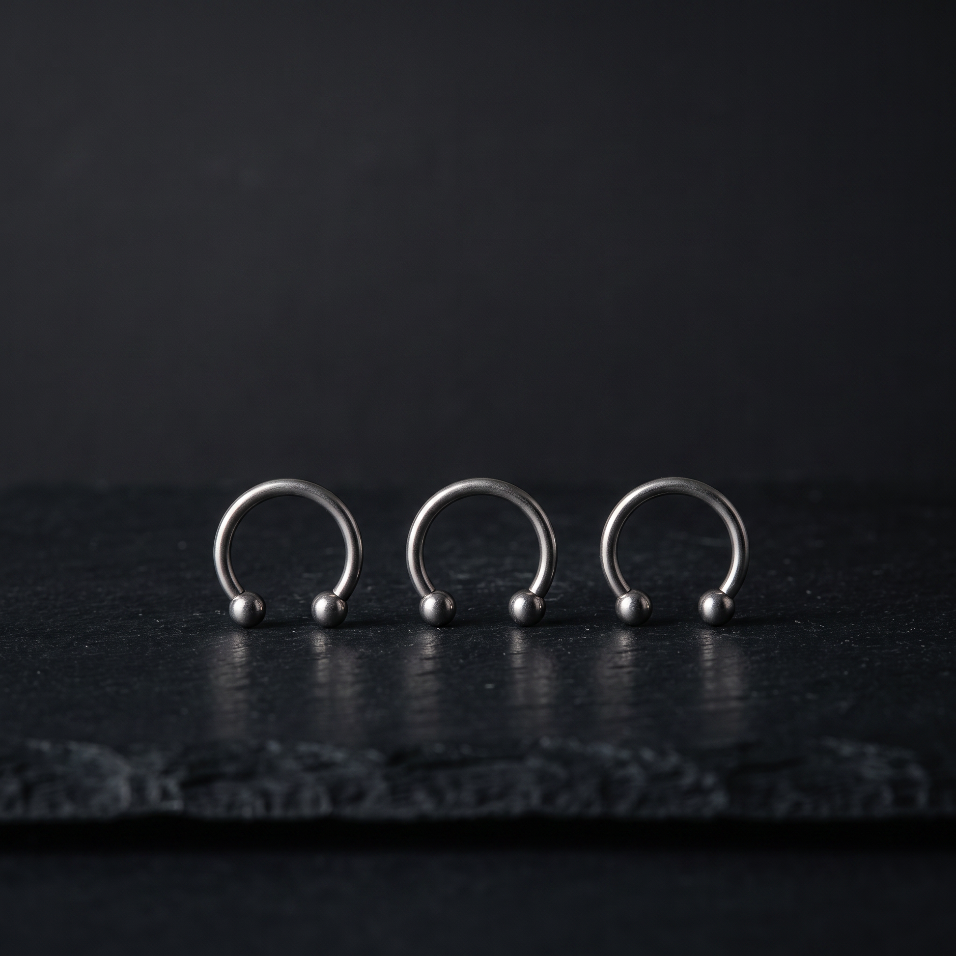 Three faux horseshoe septum rings product shot
