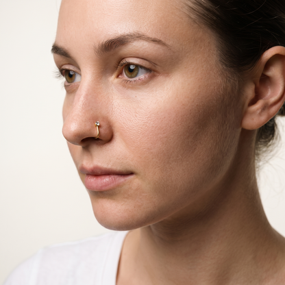L-shaped crystal nose stud worn in the nostril