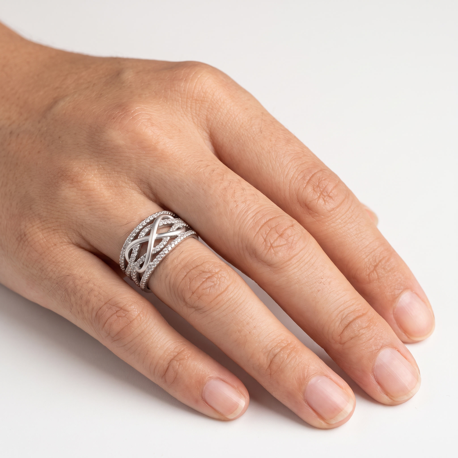 Pavé infinity ring worn, front view