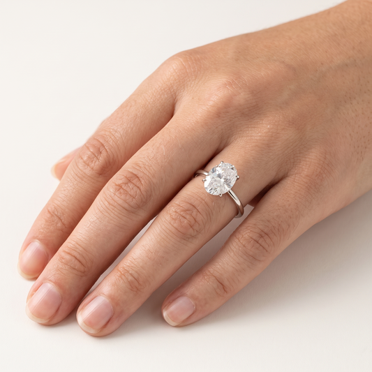 Moissanite oval solitaire ring worn, front view