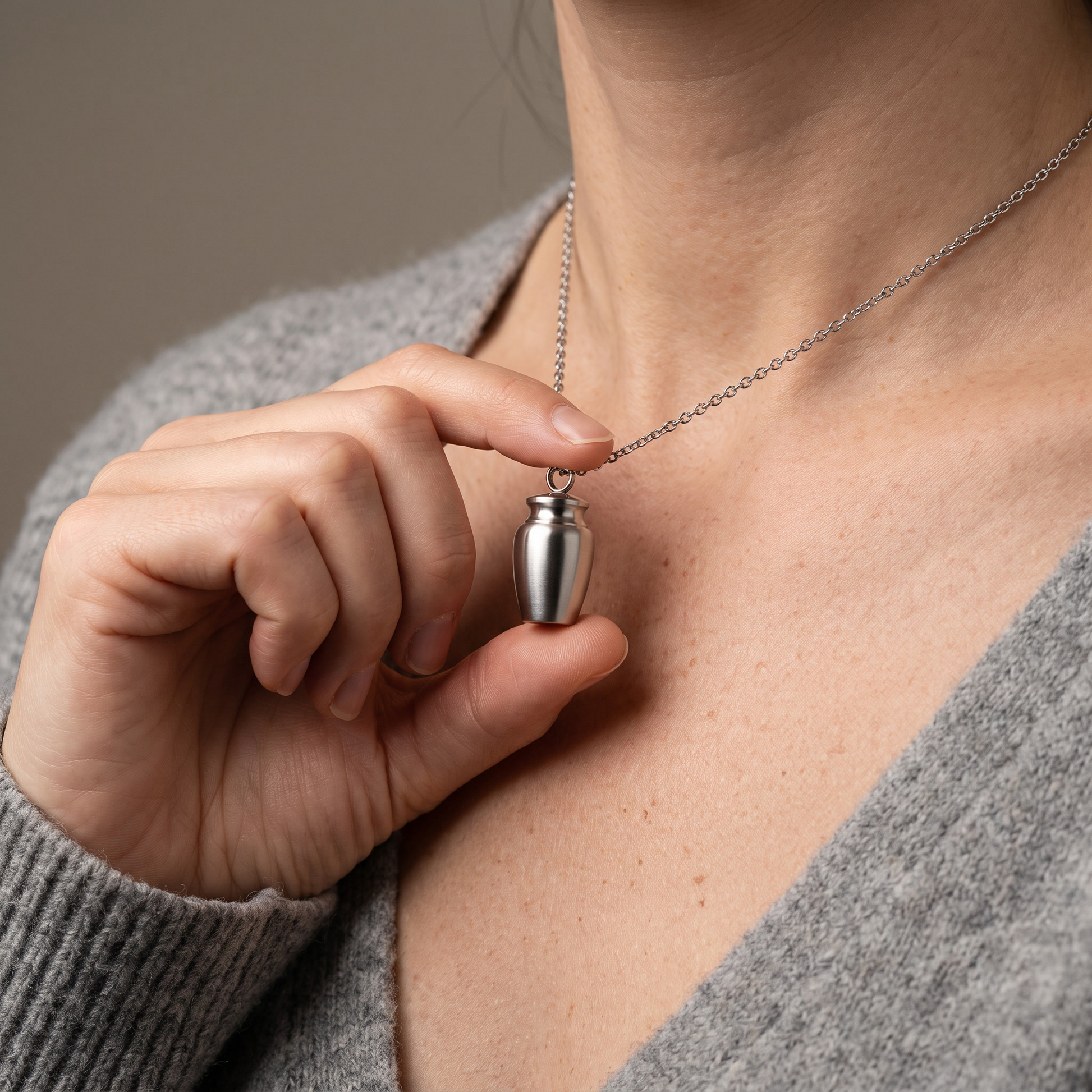 Cremation urn pendant held, second angle