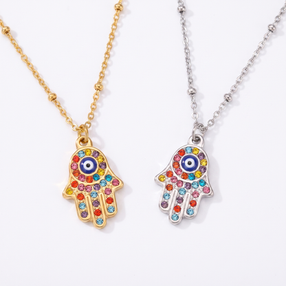 Hamsa necklace shown in gold and silver