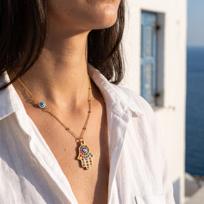Hamsa evil eye necklace worn, front view