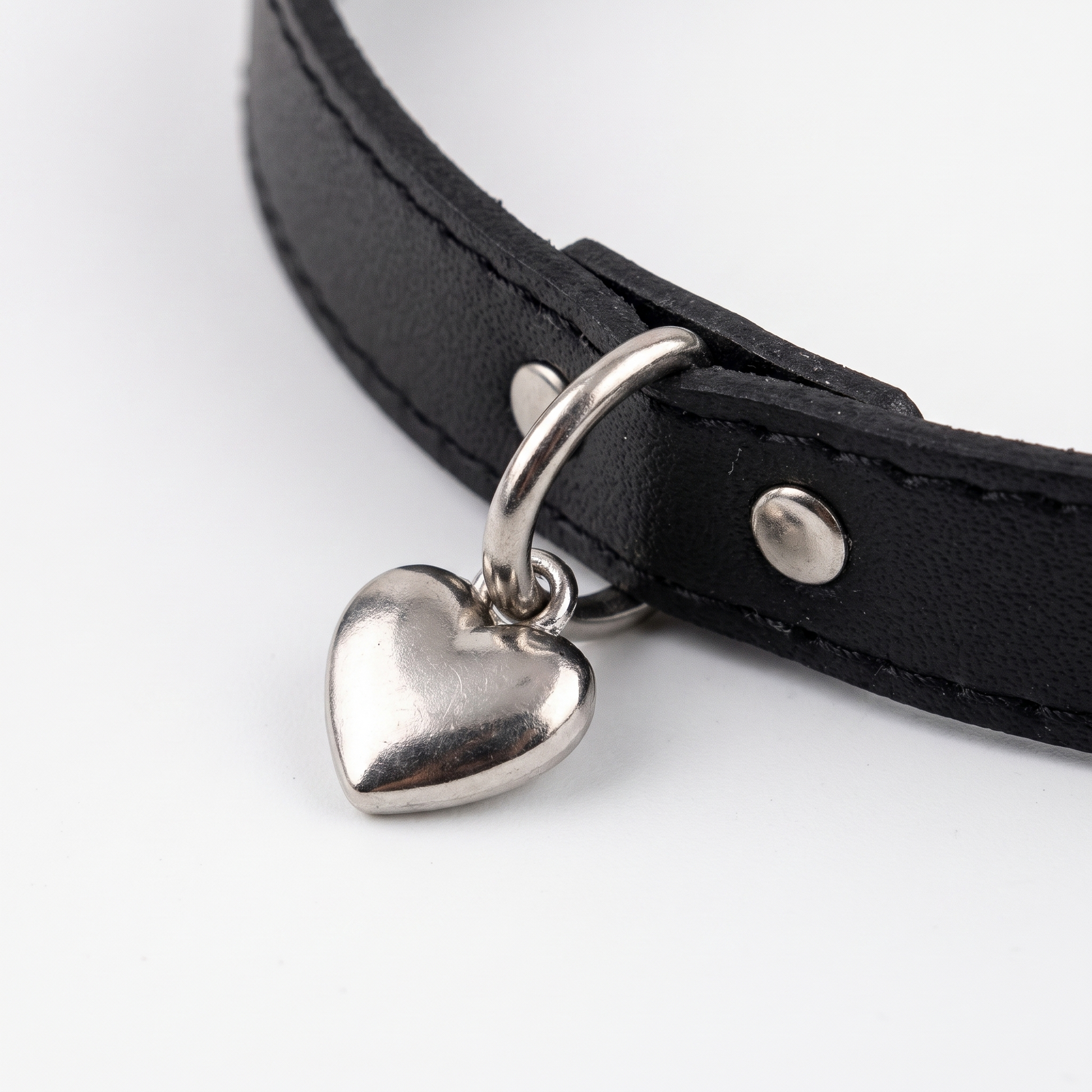 Close-up of rivets and heart charm