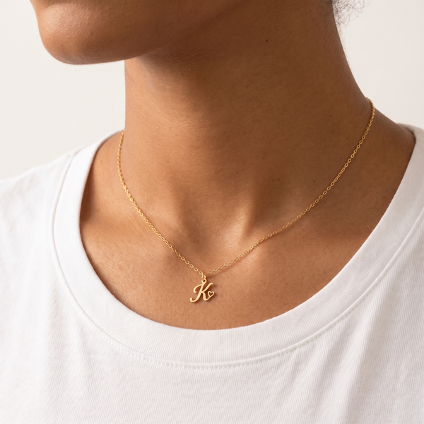 Heart initial necklace worn, second angle