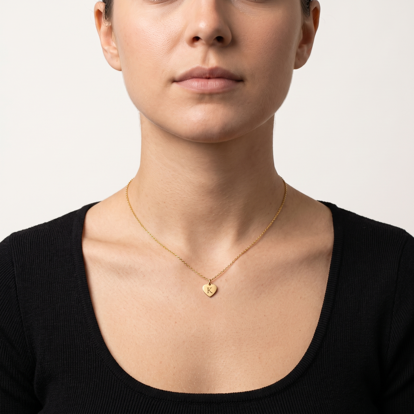 Heart initial necklace worn, front view