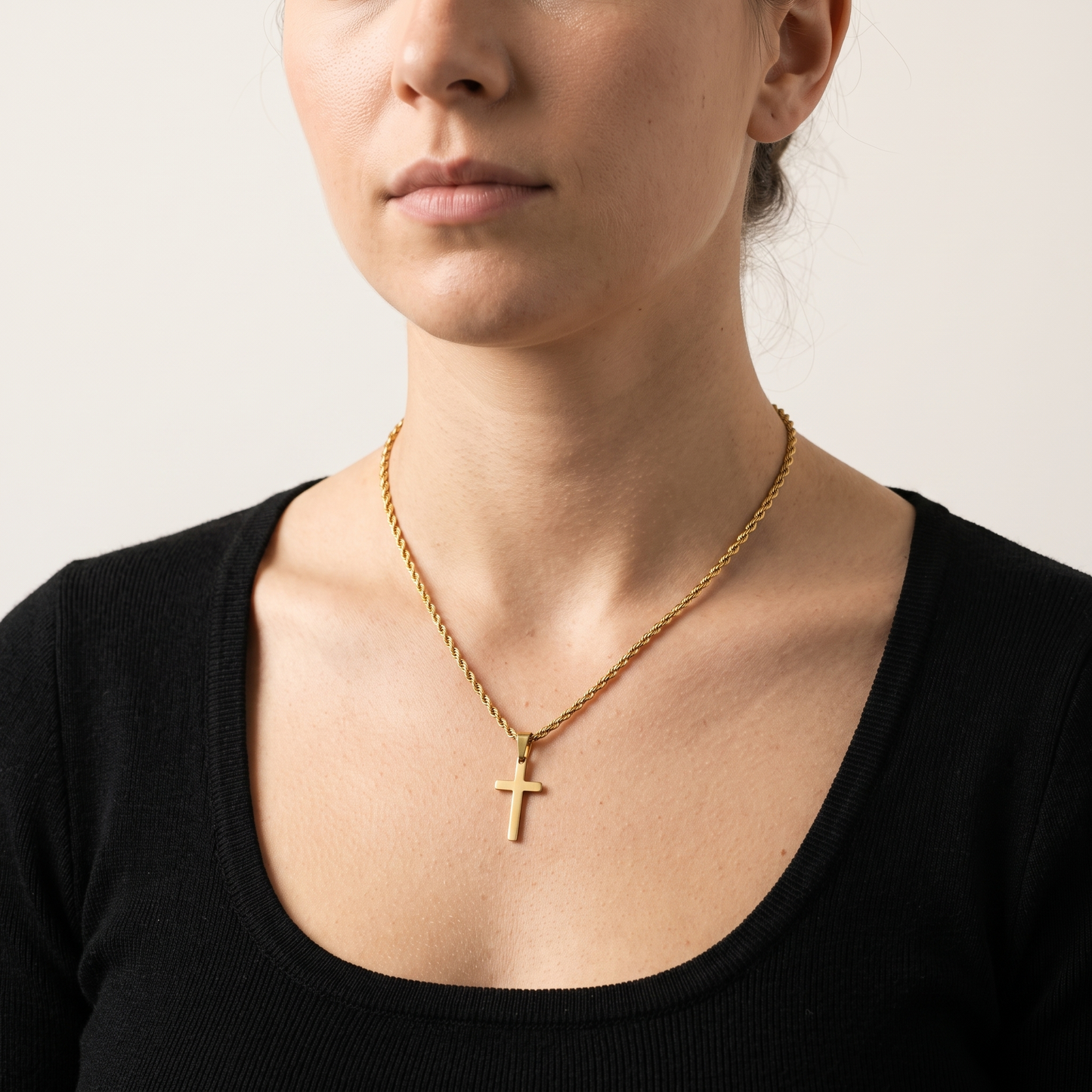Minimalist cross necklace worn, front view