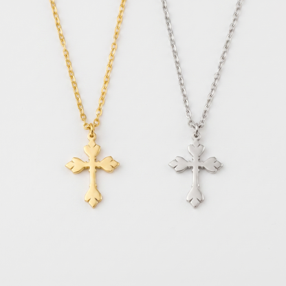 O-link cross pendant shown in gold and silver
