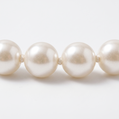 Close-up of pearls on cotton thread