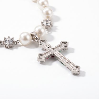 Close-up of cross pendant and pearl chain