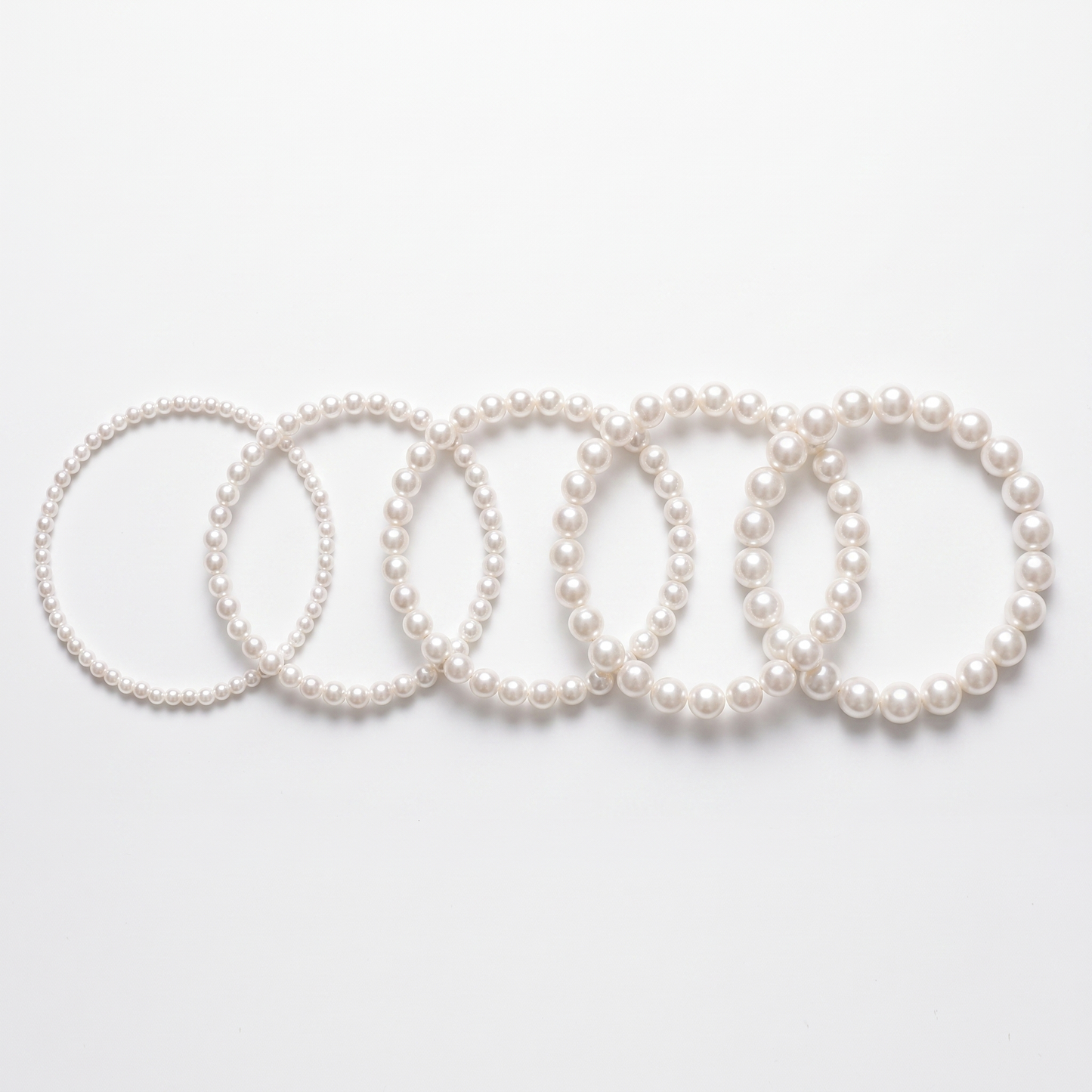 Pearl chokers shown in five bead sizes