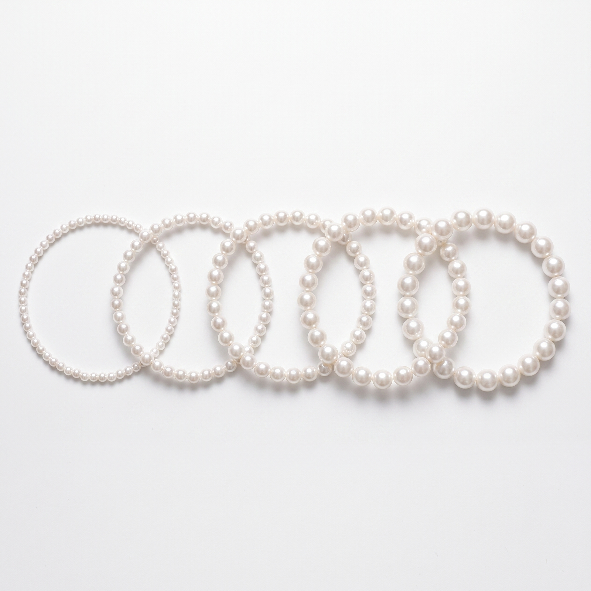 Pearl chokers shown in five bead sizes