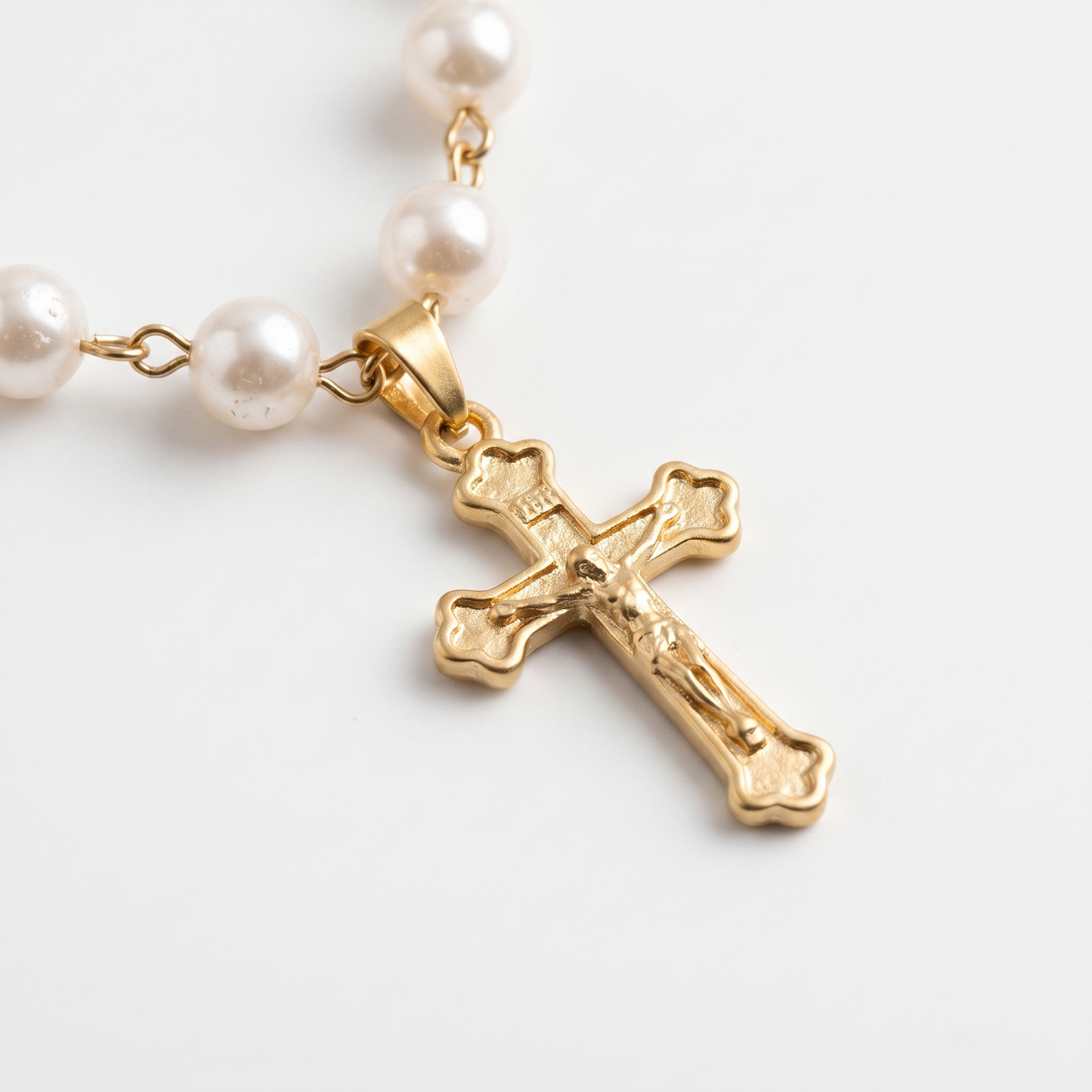 Close-up of cross charm and pearl layers