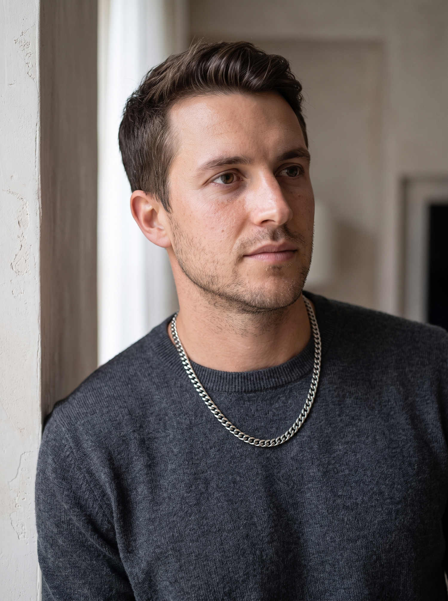 Aurelle Cuban curb chain worn with a charcoal sweater