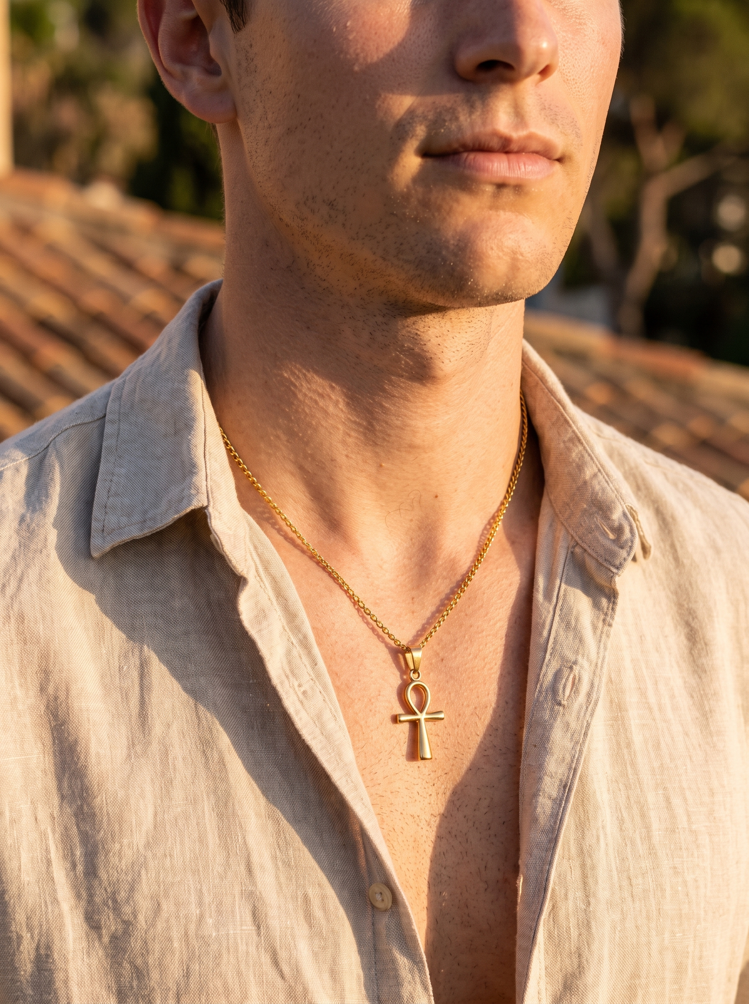 Aurelle Egyptian ankh necklace worn on a terrace