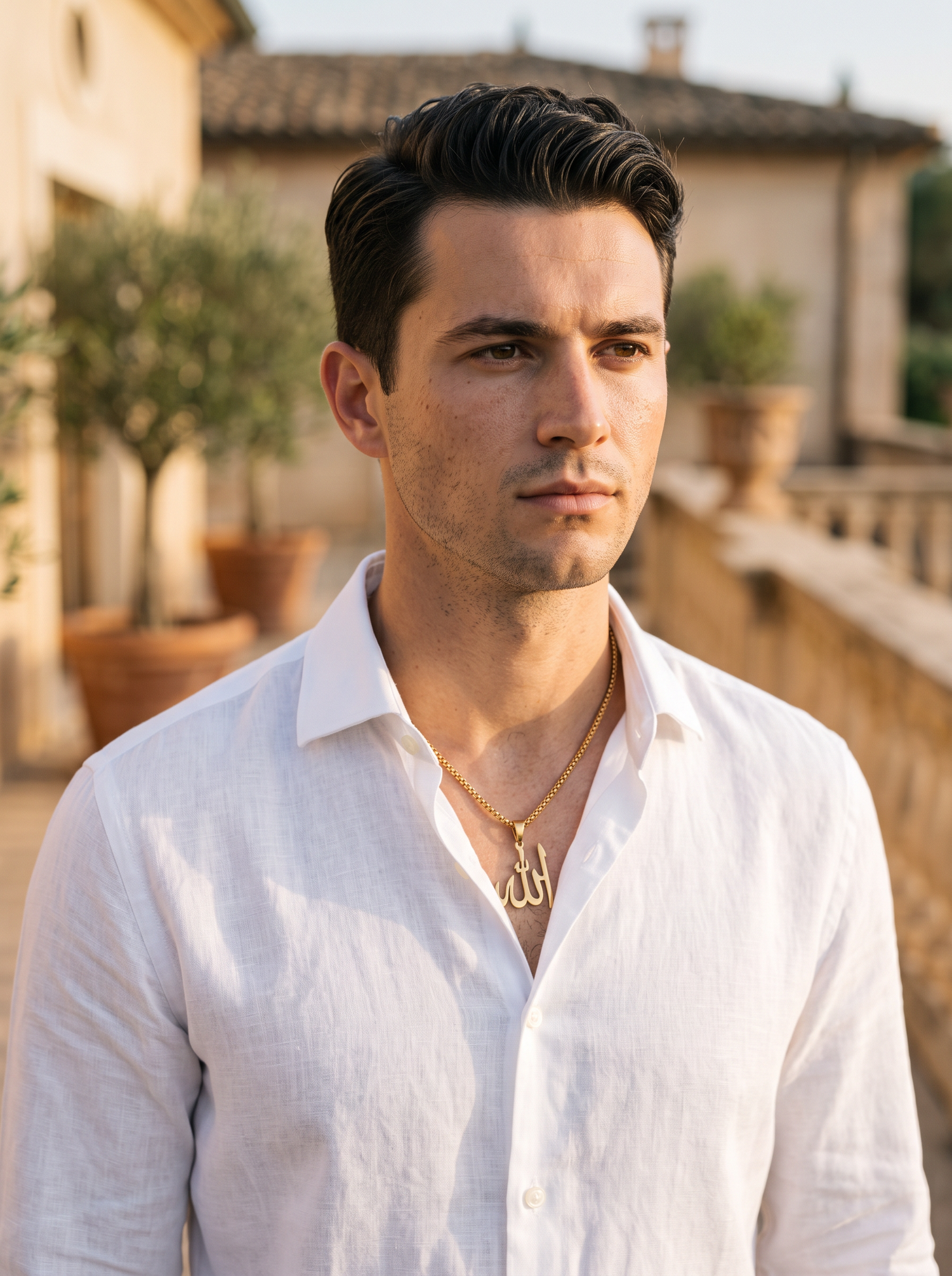Aurelle Allah calligraphy necklace worn on a terrace