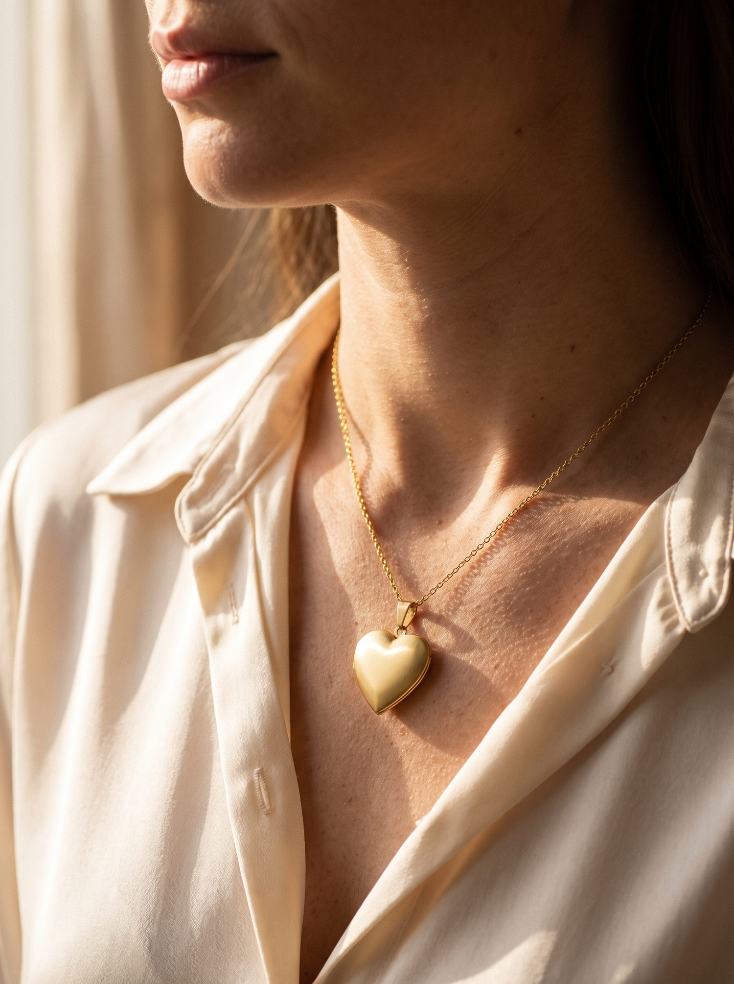 Aurelle heart locket worn closed at the collarbone
