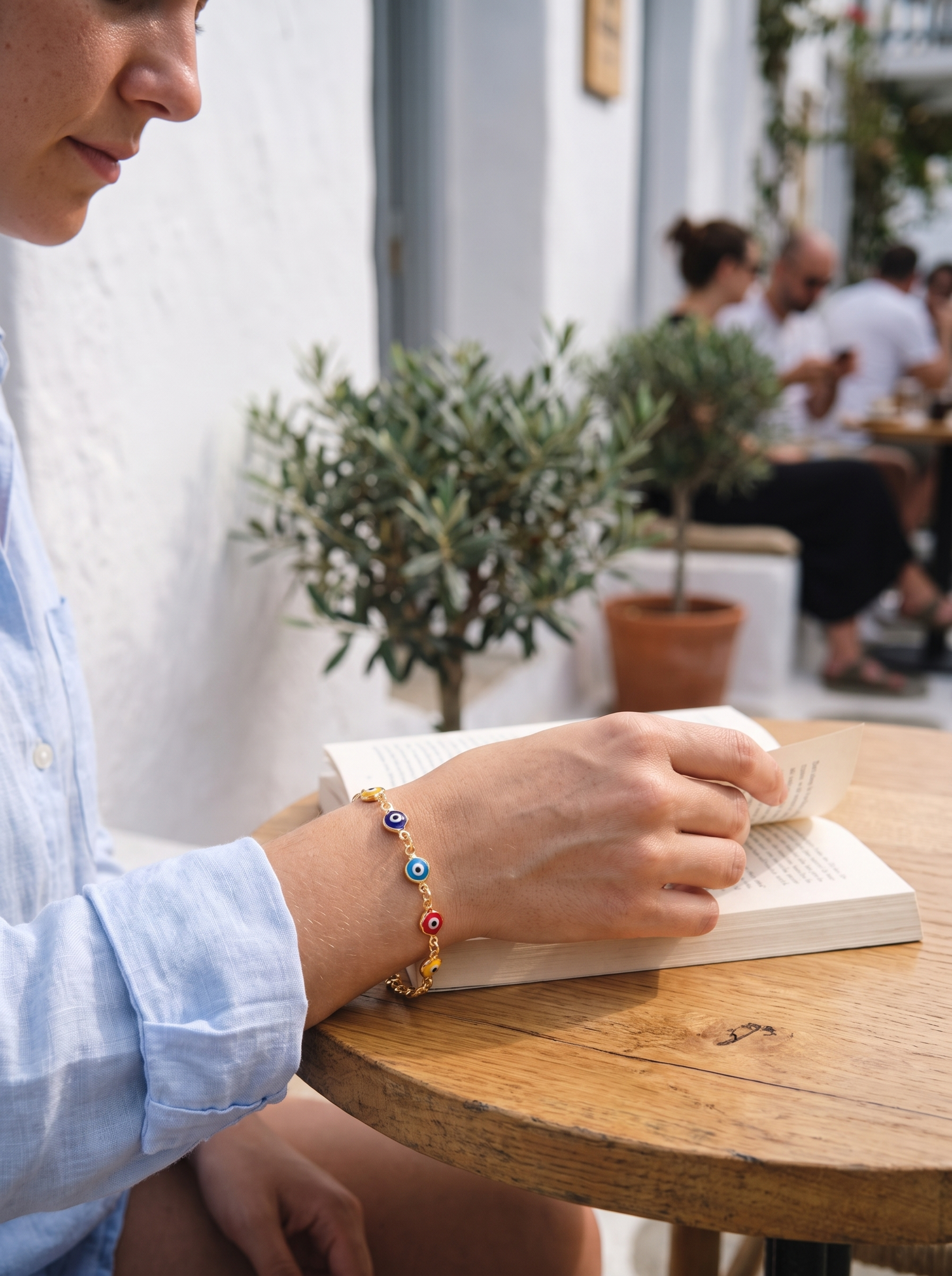 Aurelle lucky evil eye bracelet worn at a cafe