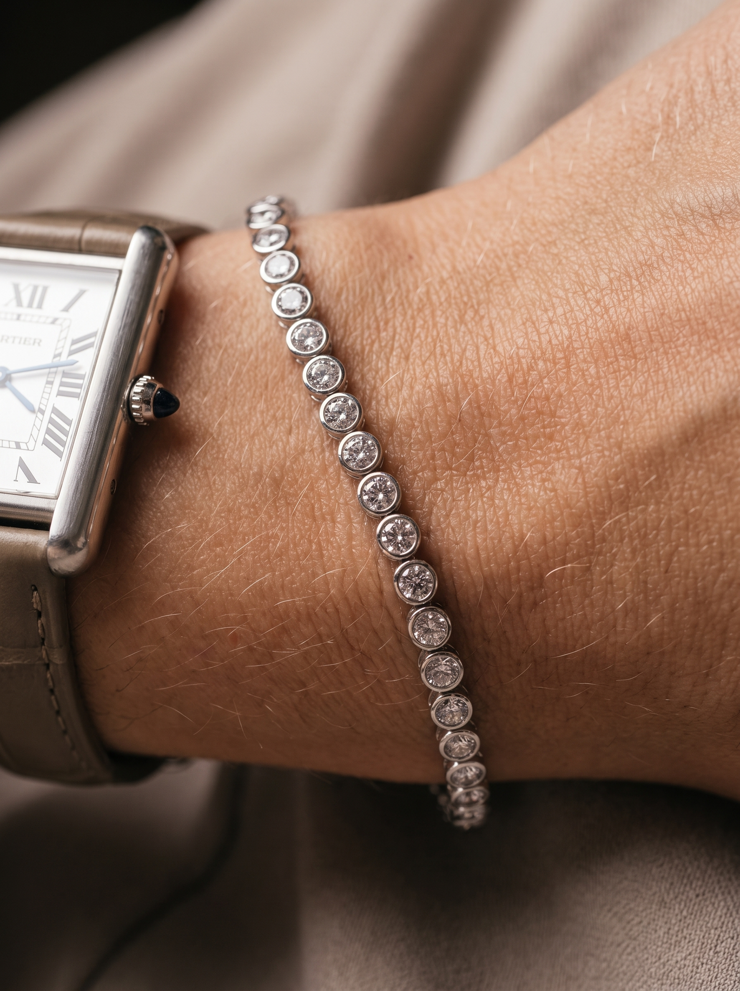 Aurelle tennis bracelet worn beside a watch