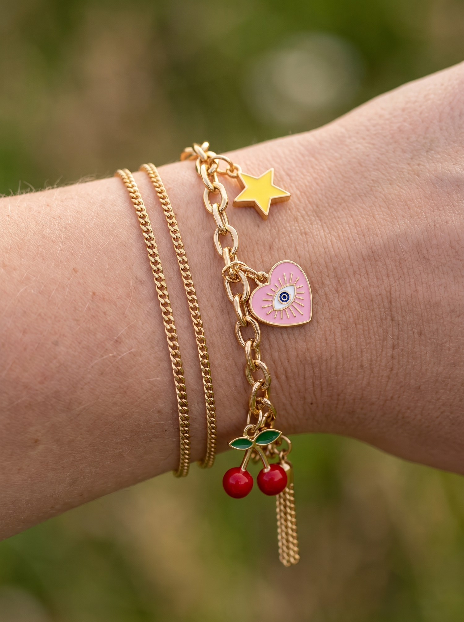 Aurelle charm bracelet stacked with chains